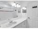 Well-lit bathroom with a large mirror, vanity, and a shower-tub combination at 9602 Lake Chase Island Way # 9602, Tampa, FL 33626