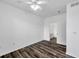 Spacious bedroom showcasing laminate floors and an ensuite bathroom at 9602 Lake Chase Island Way # 9602, Tampa, FL 33626