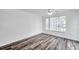 Bright bedroom featuring wood-look flooring and a ceiling fan at 9602 Lake Chase Island Way # 9602, Tampa, FL 33626