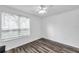 A bright bedroom showcasing wood floors and a large window with natural light at 9602 Lake Chase Island Way # 9602, Tampa, FL 33626