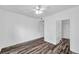 Bright bedroom featuring sleek, dark wood floors and a modern ceiling fan at 9602 Lake Chase Island Way # 9602, Tampa, FL 33626