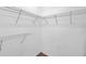 Walk-in closet showing installed metal racks for organization at 9602 Lake Chase Island Way # 9602, Tampa, FL 33626