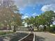 Gated entrance to community, enhanced with mature trees and manicured landscaping at 9602 Lake Chase Island Way # 9602, Tampa, FL 33626