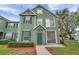 Well-maintained green home with beautiful landscaping and green shutters at 9602 Lake Chase Island Way # 9602, Tampa, FL 33626
