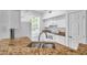 Well-lit kitchen with granite countertops and white appliances at 9602 Lake Chase Island Way # 9602, Tampa, FL 33626