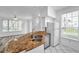 Well-lit kitchen includes granite countertops, a stainless steel sink, and white appliances with a view of the living area at 9602 Lake Chase Island Way # 9602, Tampa, FL 33626