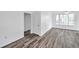 Light-filled living room featuring wood-look floors and a neutral color palette at 9602 Lake Chase Island Way # 9602, Tampa, FL 33626
