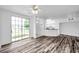 Bright living room boasts wood floors and sliding glass doors to patio at 9602 Lake Chase Island Way # 9602, Tampa, FL 33626