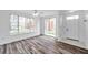 Open-concept living area with wood floors and access to outdoor spaces at 9602 Lake Chase Island Way # 9602, Tampa, FL 33626