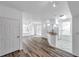 Open-concept living room and kitchen area with wood-look floors, white tile, and plenty of natural light at 9602 Lake Chase Island Way # 9602, Tampa, FL 33626
