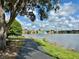 Scenic view of pond with fountain and walking path; a serene outdoor space at 9602 Lake Chase Island Way # 9602, Tampa, FL 33626