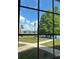 Scenic view of lakefront homes and lush landscaping through a window at 9602 Lake Chase Island Way # 9602, Tampa, FL 33626