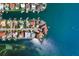 Stunning aerial view of a waterfront home with lush landscaping, private dock, and expansive water access at 100 Sands Point Dr, Tierra Verde, FL 33715
