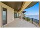 Water view from the home's balcony with tiled flooring and decorative black wrought-iron railings at 100 Sands Point Dr, Tierra Verde, FL 33715