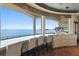 Window-encased bar seating area offering water and island views at 100 Sands Point Dr, Tierra Verde, FL 33715