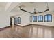 Large bedroom with hardwood floors, ceiling fan, and three windows with shutters at 100 Sands Point Dr, Tierra Verde, FL 33715