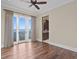Bright bedroom with hardwood floors, balcony access, and views of the water at 100 Sands Point Dr, Tierra Verde, FL 33715