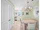 Cozy dining area features a chandelier, a table with four chairs and views into the kitchen at 100 Sands Point Dr, Tierra Verde, FL 33715