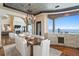 Elegant dining room featuring a chandelier, seating for eight, and serene water views at 100 Sands Point Dr, Tierra Verde, FL 33715