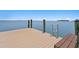 Wooden dock featuring durable beams, a steel ladder, and open access to the water at 100 Sands Point Dr, Tierra Verde, FL 33715