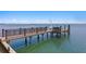 Private wooden dock and railing with access to the water at 100 Sands Point Dr, Tierra Verde, FL 33715