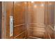 Interior view of the in-home elevator with wood paneling at 100 Sands Point Dr, Tierra Verde, FL 33715