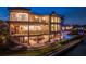 Beautiful waterfront estate with outdoor bar, inviting pool, and elegantly designed balconies, perfect for upscale living at 100 Sands Point Dr, Tierra Verde, FL 33715