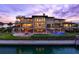 Stunning waterfront home featuring a pool, covered patio, and meticulously manicured lawn, offering luxurious outdoor living at 100 Sands Point Dr, Tierra Verde, FL 33715