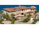 Stunning waterfront home featuring a private gated entrance and lush tropical landscaping at 100 Sands Point Dr, Tierra Verde, FL 33715