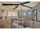 Stunning foyer with stone accent wall, chandelier, and wrought iron railing at 100 Sands Point Dr, Tierra Verde, FL 33715