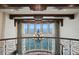 Elegant foyer featuring large windows with water views, chandelier, and wrought iron railing at 100 Sands Point Dr, Tierra Verde, FL 33715