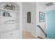 Hallway features built-in shelving and a staircase with a wooden handrail at 100 Sands Point Dr, Tierra Verde, FL 33715