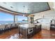 Gourmet kitchen boasting a large island, water views, and luxury appliances at 100 Sands Point Dr, Tierra Verde, FL 33715