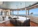 Open-concept kitchen with a large island, bar seating, and stunning water views at 100 Sands Point Dr, Tierra Verde, FL 33715
