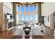 Elegant living room featuring high ceilings, fireplace, and panoramic water views at 100 Sands Point Dr, Tierra Verde, FL 33715