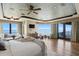 Beautiful main bedroom with water views, seating, and decorative ceiling detail at 100 Sands Point Dr, Tierra Verde, FL 33715