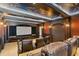 Movie room with tiered seating, leather recliners, and blue and gold decorated ceiling at 100 Sands Point Dr, Tierra Verde, FL 33715