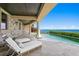 Outdoor patio with seating and ocean views at 100 Sands Point Dr, Tierra Verde, FL 33715