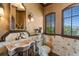 Stylish powder room with elegant fixtures, decorative mirror, and window with shutters at 100 Sands Point Dr, Tierra Verde, FL 33715