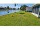 Beautiful green grass with a lake in the backyard, perfect for relaxation and outdoor activities at 10040 38Th N Way, Pinellas Park, FL 33782