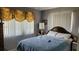 Comfortable bedroom with a cozy bed, soft lighting, and neutral wall colors at 10040 38Th N Way, Pinellas Park, FL 33782