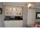 Elegant display cabinet with glass doors and lighting in the dining area, complemented by modern decor at 10040 38Th N Way, Pinellas Park, FL 33782