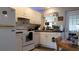 Functional kitchen with white appliances, light wood cabinetry, and ample counter space at 10040 38Th N Way, Pinellas Park, FL 33782