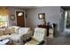 Bright living room with cozy seating, neutral carpet, and view into bathroom at 10040 38Th N Way, Pinellas Park, FL 33782