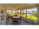 Bright sun room with a ceiling fan, tiled floors and views of the water at 10040 38Th N Way, Pinellas Park, FL 33782