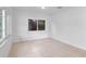 Bedroom featuring tiled floors and a large picture window at 10208 N 23Rd St, Tampa, FL 33612