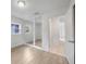 Bedroom featuring wood laminate flooring and mirrored closet doors, maximizing space and light at 10208 N 23Rd St, Tampa, FL 33612