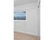 Bedroom featuring wood laminate flooring, natural lighting through the window, and a serene atmosphere at 10208 N 23Rd St, Tampa, FL 33612