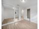 Bedroom featuring wood laminate flooring and mirrored closet doors, providing functionality at 10208 N 23Rd St, Tampa, FL 33612