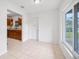 Bright entryway with tile flooring, white walls, and natural light from the window at 10208 N 23Rd St, Tampa, FL 33612